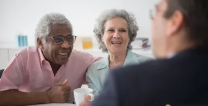 Elder law attorney talking to senior couple about their in-home care needs